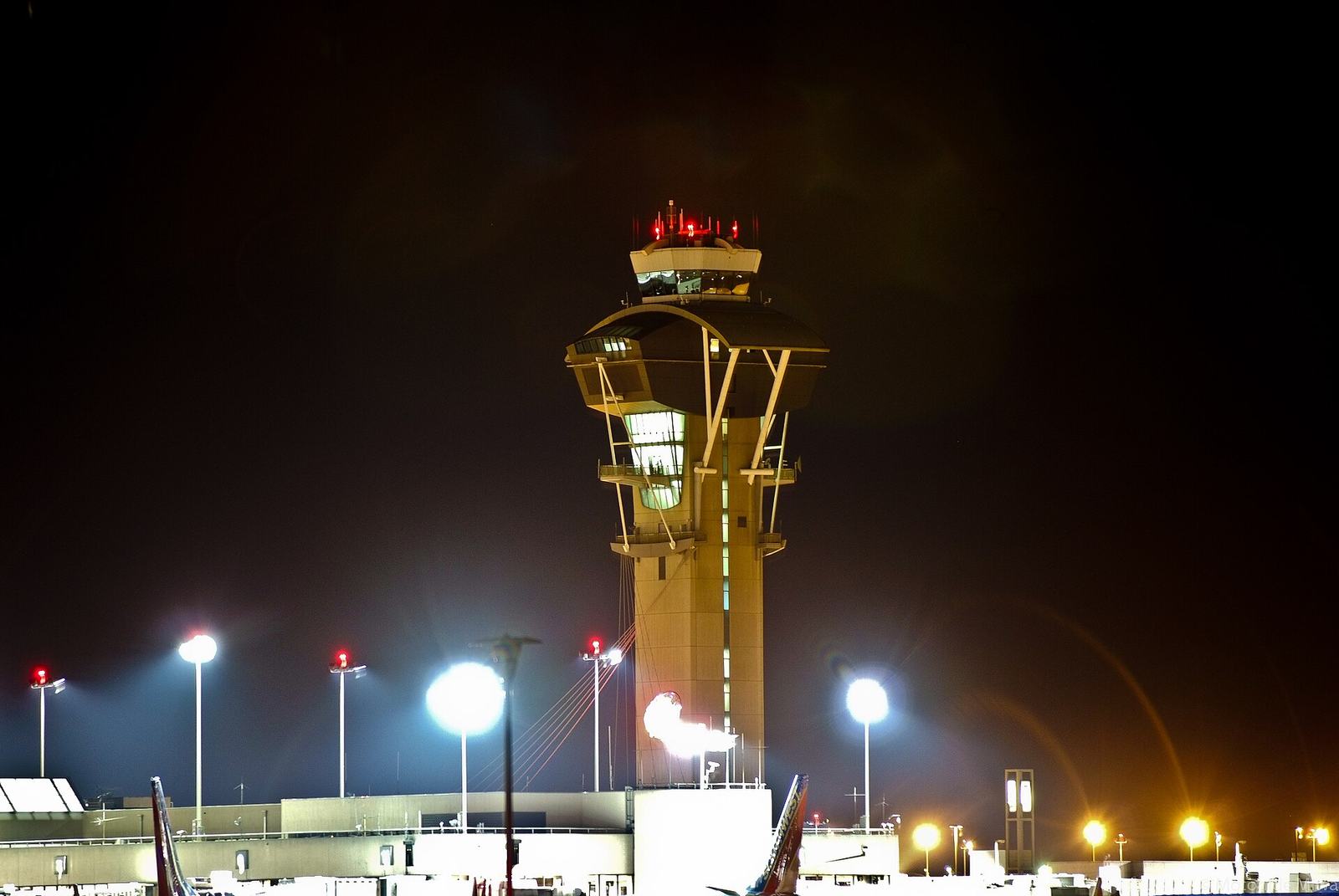 Airport control tower lit up at night