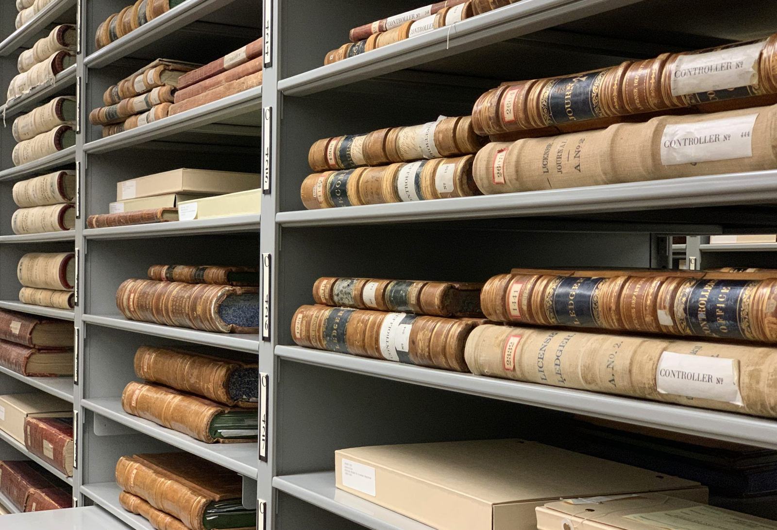 Shelves of old bound record ledgers in an archive