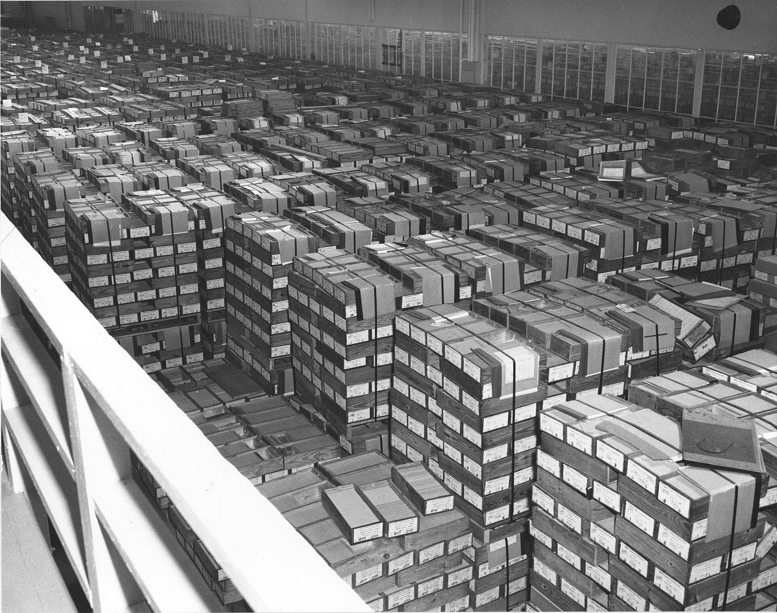 Warehouse floor stacked with thousands of boxed record cards