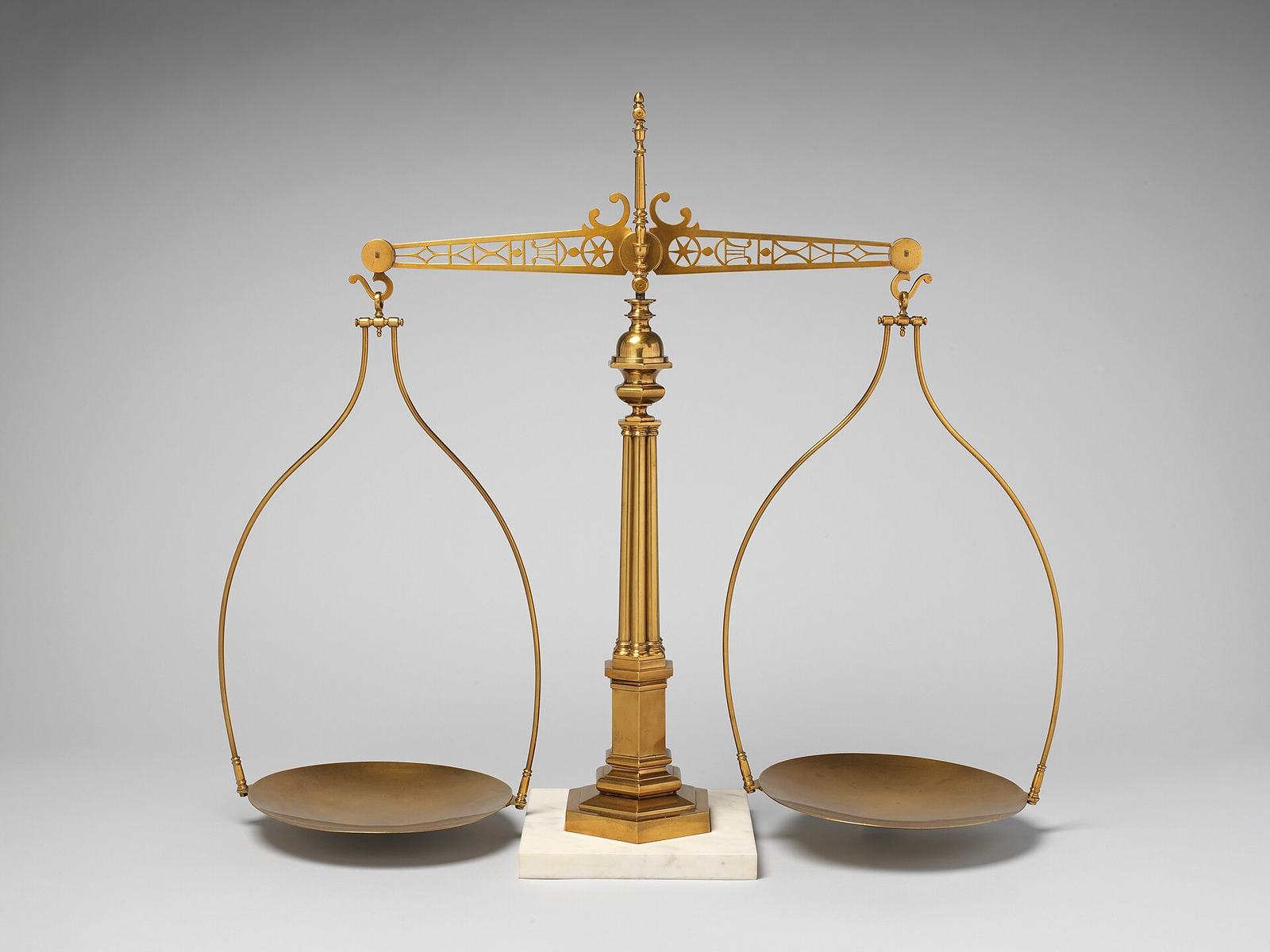 Antique brass balance scale with two pans