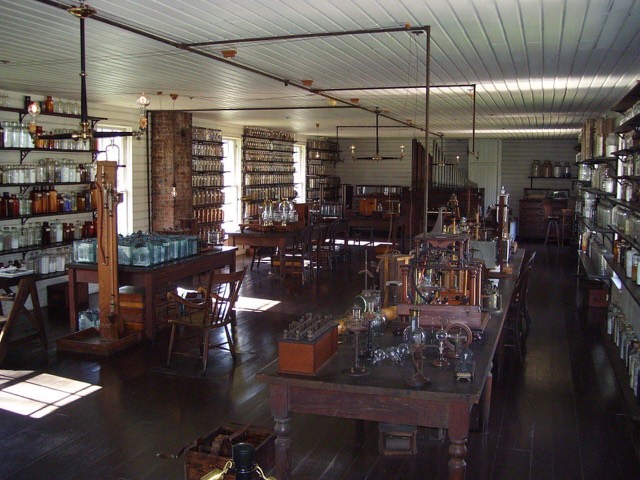 Thomas Edison's Menlo Park laboratory, with long workbenches, glassware and shelves of bottles